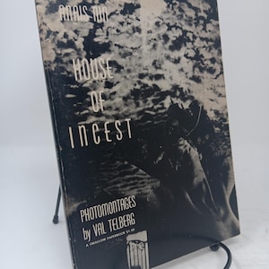 May include: A vintage paperback book titled "House of Incest" by Anais Nin, with photomontages by Val Telberg. The cover is black and white, featuring a cloudy sky design and a grayscale image. The book is displayed on a black metal stand.