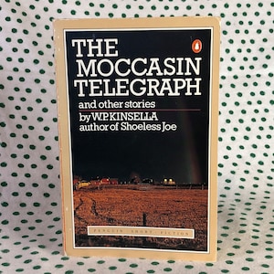 May include: A book cover with a brown background and the title "The Moccasin Telegraph" in white text. The subtitle is "and other stories" and the author is "W.P. Kinsella". The book is a Penguin Short Fiction.