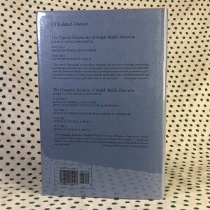 May include: A blue book cover with the title "The Complete Sermons of Ralph Waldo Emerson" and the author's name "Albert J. Von Frank, Chief Editor". The book cover also includes a list of the volumes and editors.