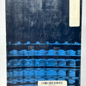 May include: A used book with a dark blue cover featuring a textured design with horizontal blue lines. A white label with text and a barcode is affixed to the cover. The book is titled "Dimensional Analysis".