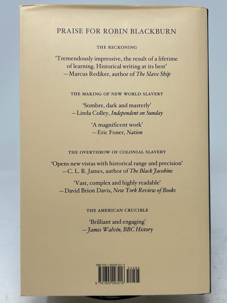 May include: The back cover of a book with text praising Robin Blackburn. Quotes from various sources are displayed, including Marcus Rediker and Linda Colley. The book's title and author are not visible. The cover is a light beige color.