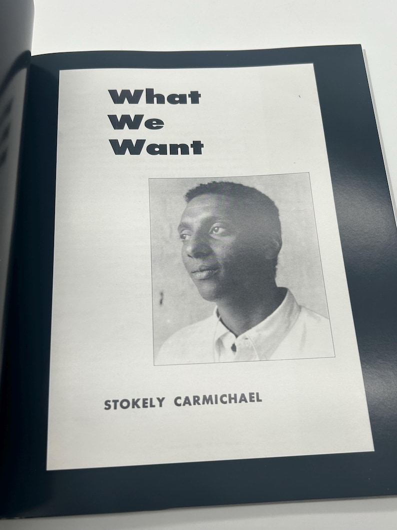 May include: A black and white image of a book page featuring the title "What We Want" in bold, black letters. Below the title is a black and white portrait of Stokely Carmichael.