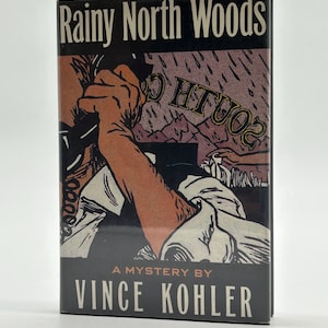 May include: A book cover for "Rainy North Woods" by Vince Kohler. The cover features a vintage illustration of a person holding a phone, with a rainy landscape and the word "South" in the background. The book is a mystery.
