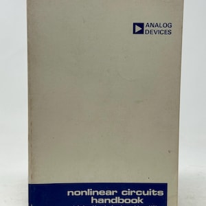 May include: A handbook titled "nonlinear circuits handbook" with the text "designing with analog function modules and IC's". The cover is off-white with a blue band at the bottom and the Analog Devices logo at the top.