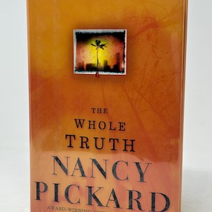 May include: A hardback book titled "The Whole Truth" by Nancy Pickard. The cover is orange with a small rectangular image of a palm tree and city skyline. The author is described as the award-winning author of Twilight.