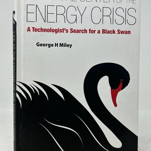 May include: A hardcover book titled "LIFE AT THE CENTER OF THE ENERGY CRISIS" with a black swan illustration. The author's name is George H Miley. The book's cover is white with black and red text. Published by World Scientific.