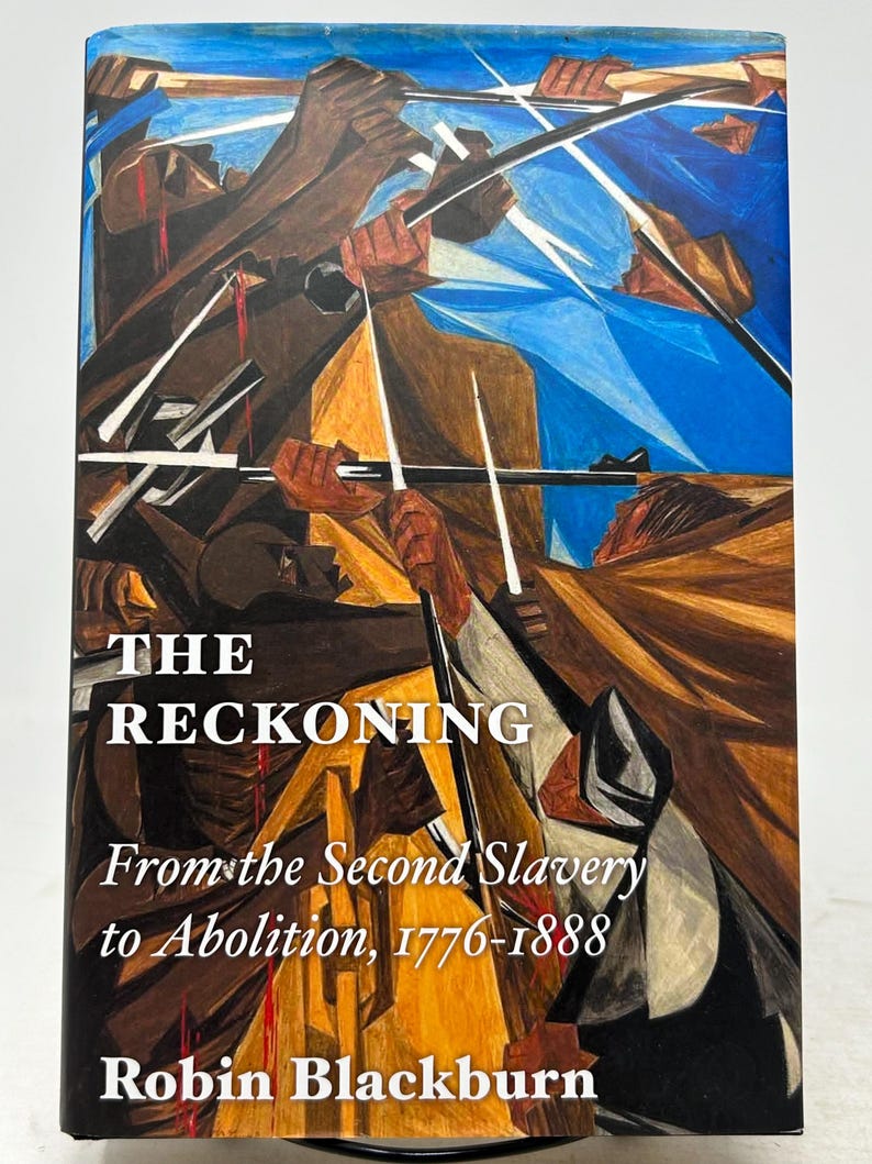 May include: A hardcover book titled "The Reckoning" with the subtitle "From the Second Slavery to Abolition, 1776-1888" by Robin Blackburn. The cover features an abstract painting with figures in brown and blue tones.