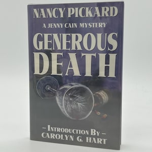 May include: A hardback book titled "Generous Death" by Nancy Pickard, part of the Jenny Cain Mystery series. The cover is dark blue with white text and features a wine glass illustration. Introduction by Carolyn G. Hart.