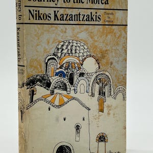 May include: A vintage book titled "Journey to the Morea" by Nikos Kazantzakis. The cover features an illustration of a building with arched windows and domes, in shades of white, black, orange, and blue. The book's spine also displays the title and author's name.