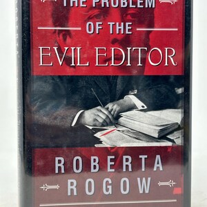 May include: A hardback book with the title "THE PROBLEM OF THE EVIL EDITOR" by Roberta Rogow. The cover has a red background with white text and an illustration of a person writing. It is a Charles Dodgson/Arthur Conan Doyle Mystery.