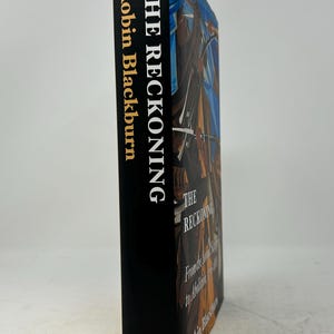 May include: A hardcover book titled "THE RECKONING" by Robin Blackburn. The spine is black with gold lettering. The book's cover features an abstract painting with shades of blue, brown, and orange. The Verso logo is at the bottom.