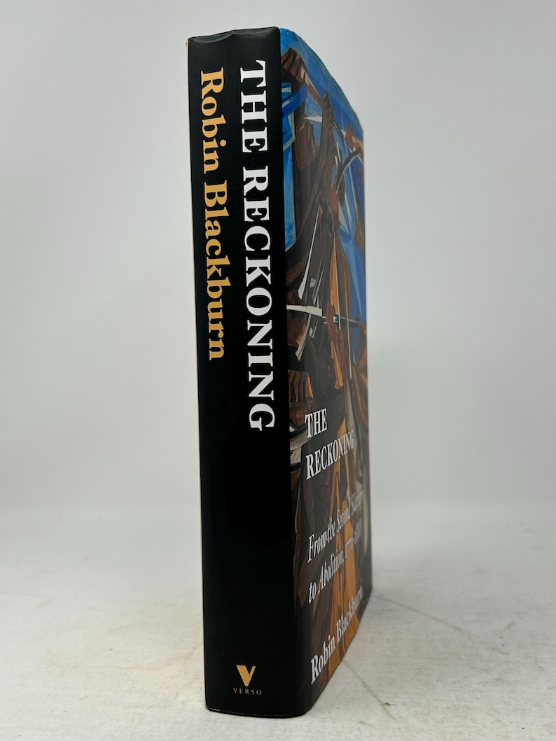 May include: A hardcover book titled "THE RECKONING" by Robin Blackburn. The spine is black with gold lettering. The book's cover features an abstract painting with shades of blue, brown, and orange. The Verso logo is at the bottom.