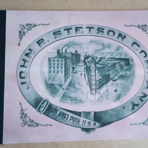 May include: A vintage pink and green logo for John B. Stetson Company, featuring a drawing of a factory building in Philadelphia, Pennsylvania, USA.