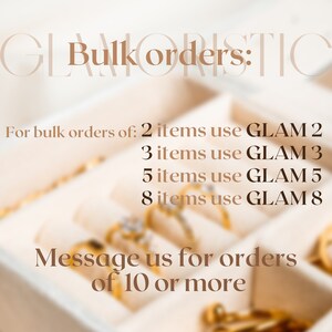 May include: A close-up image of a jewelry display with gold rings in a white box. The text reads "Bulk orders: 2 items use GLAM 2, 3 items use GLAM 3, 5 items use GLAM 5, 8 items use GLAM 8. Message us for orders of 10 or more."