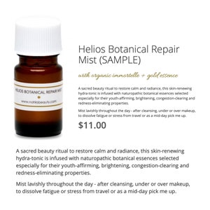 May include: A small amber glass bottle with a white label that reads "Helios Botanical Repair Mist (SAMPLE)" with organic immortelle + gold essence. The bottle is sitting on a white background. The text "$11.00" is visible below the bottle.