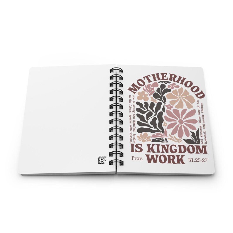 May include: A spiral bound journal with a white cover and a floral design. The text on the cover reads "Motherhood is Kingdom Work Prov. 31:25-27".