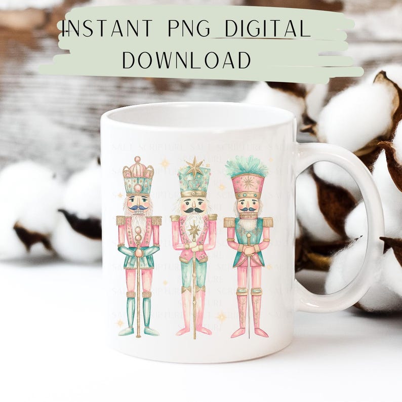 May include: White ceramic mug with a design of three pink and green nutcracker soldiers. The nutcrackers are standing in a row and have gold accents. The mug has a handle on the right side.