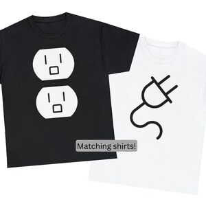 May include: Two matching t-shirts. One black t-shirt features a white electrical outlet graphic. The other is white with a black plug graphic. The text "Matching shirts!" is displayed below the shirts.