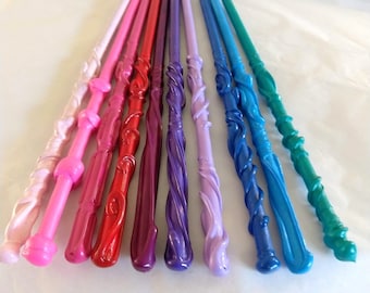 May include: A set of ten colorful wands with a swirling design. The wands are made of a smooth, shiny material and are arranged in a rainbow pattern.