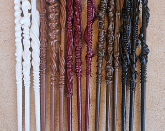 May include: A set of 13 wooden wands, each with a unique design and color. The wands are arranged in a row, with the white wands on the left and the black wands on the right. The wands are all about 12 inches long.