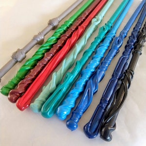 May include: A set of ten colorful, twisted wands, each with a unique design and color. The wands are made of a smooth, shiny material and are arranged in a row on a white surface.