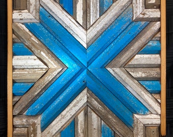 May include: A square wall art piece made of wood with a geometric pattern of blue and white painted stripes. The wood is weathered and has a rustic look.