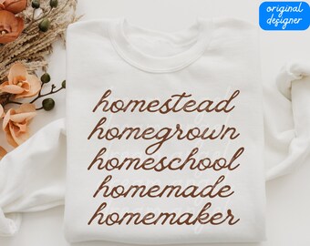May include: White sweatshirt with the words "homestead", "homegrown", "homeschool", "homemade", and "homemaker" written in brown cursive lettering.
