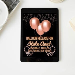 May include: A digital invitation on a tablet screen with a black background and rose gold balloons. The text reads "Balloon Release for Kate Ann! Saturday, April 28 - Topa Drive, New Jersey".