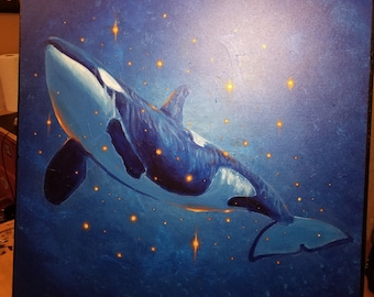 May include: An original painting of an orca whale swimming in a dark blue ocean. The whale is depicted in shades of blue and white, with glowing orange stars scattered around it. The artwork is on a square canvas.