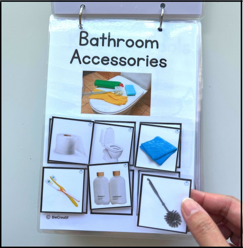 May include: A set of bathroom accessories including a toilet brush, toilet paper, toilet bowl cleaner, hand soap, a blue washcloth, and a toothbrush and toothpaste.