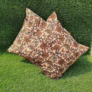 May include: Two cream-colored pillowcases with a brown and black floral pattern. The pillowcases are made of cotton and have a soft, comfortable feel.