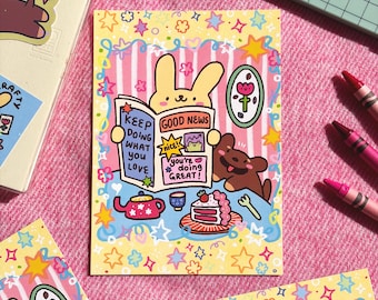 May include: A colorful illustration featuring a bunny reading a newspaper with the headline "Good News" and the text "Keep Doing What You Love." A brown bear, cake, and teapot are also depicted. The design is surrounded by stars and flowers.