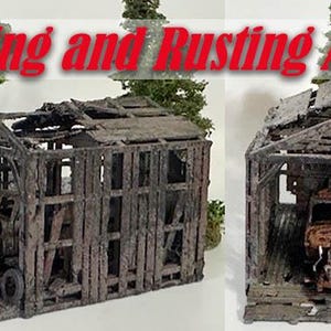 May include: Miniature model of a weathered wooden shed with a rusted vehicle inside. The shed's roof is partially collapsed, and the wood is aged. The text "Rotting and Rusting Away" is displayed above the shed.