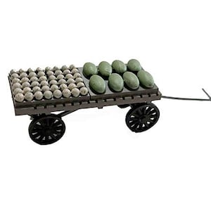 May include: A wooden cart with two wheels, carrying a variety of green and gray round objects. The cart has a metal handle and is on a white background.