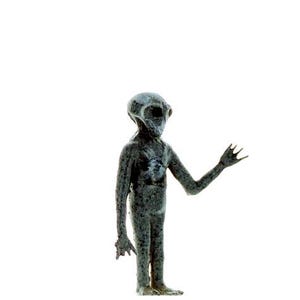 May include: A gray alien figurine with a large head and large eyes, standing with one arm raised and one hand open.