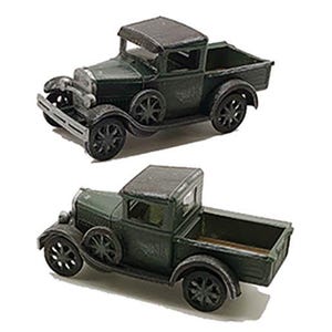 May include: Two vintage green toy pickup trucks with black wheels. The trucks have a flatbed and a cab with a black roof.