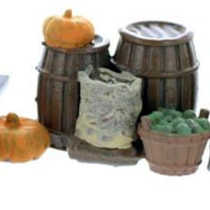 May include: A miniature market stall display with various items for sale, including pumpkins, sacks of grain, barrels, and baskets of produce. The stall is made of wood and has a rustic appearance.