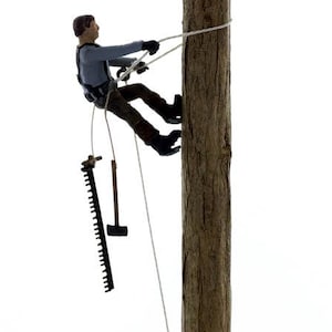 May include: A figure of a person climbing a tree with a rope and a saw hanging from their belt.