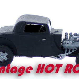 May include: A black vintage hot rod model car with a detailed engine and a classic coupe body style.