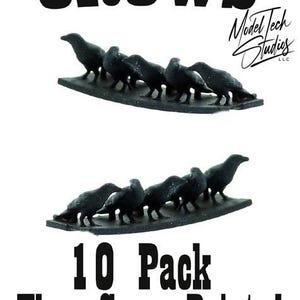 May include: A pack of 10 black crows, painted and ready to use. The crows are arranged in a line, facing the same direction. The text "Crows" is at the top of the image, and the text "10 Pack They Come Painted" is at the bottom of the image.