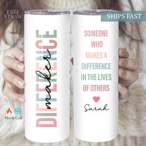 May include: White tumbler with a pink, green, and blue design that says "Difference maker". The other side of the tumbler says "Someone who makes a difference in the lives of others" with a pink heart and the name "Sarah".