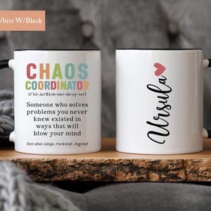May include: Two 11 ounce white ceramic mugs with black handles and black rims. One mug has the text "CHAOS COORDINATOR" with a definition and the text "See also: ninja, rockstar, legend". The other mug has the text "Ursula" with a pink heart above it.