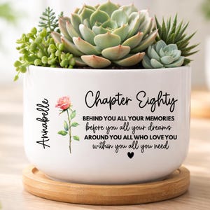 May include: A rustic wooden sign with the text "Welcome to our home" in white lettering. The sign features a distressed finish and a simple, inviting design, perfect for front door decor.