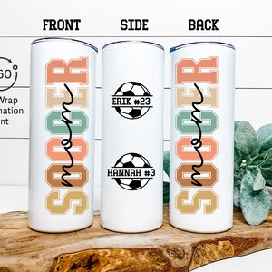 May include: White tumbler with a full wrap sublimation print of the word "Soccer" in colorful letters. The side of the tumbler features a soccer ball with the text "Erik #23" and another soccer ball with the text "Hannah #3".