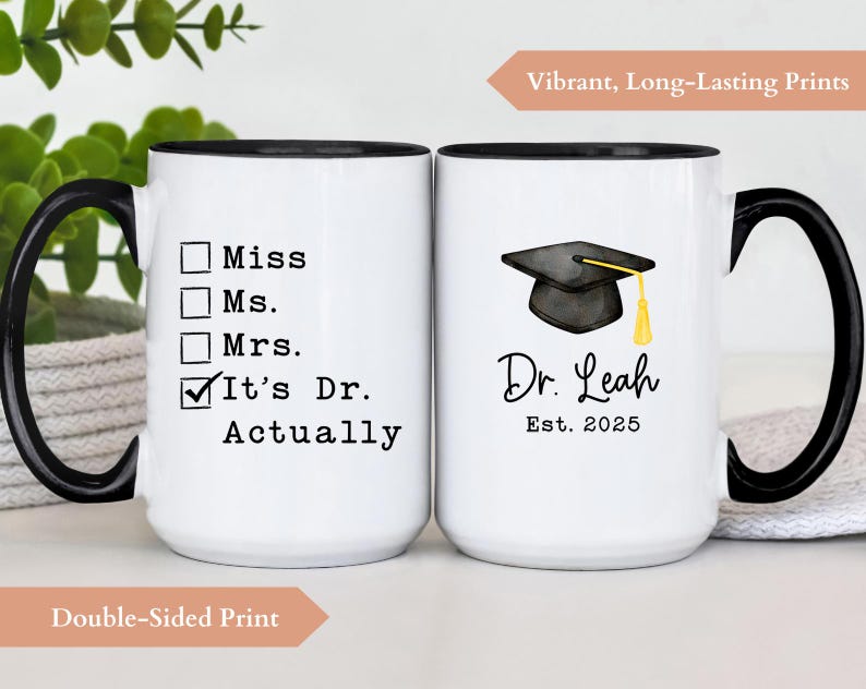 May include: White ceramic mug with a black handle and rim. One side reads "It's Dr. Actually" with check boxes. The other side features a graduation cap graphic and the text "Dr. Leah Est. 2025".