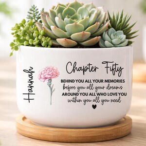 May include: A rustic wooden sign with the text "Welcome to our home" in white lettering. The sign features a distressed finish and a simple, inviting design, perfect for front door decor.