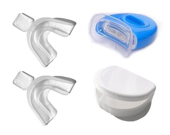 May include: Two clear plastic teeth whitening trays, a blue and white teeth whitening light, and a white plastic storage container.