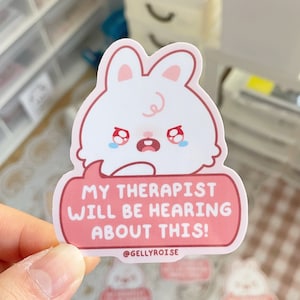 cute, white, crying bunny saying "My therapist will be hearing about this!" pink sticker