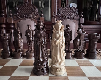 May include: A chess set with intricately carved wooden pieces. The queen pieces are a dark brown and a light cream color. The pieces are arranged on a wooden chessboard.
