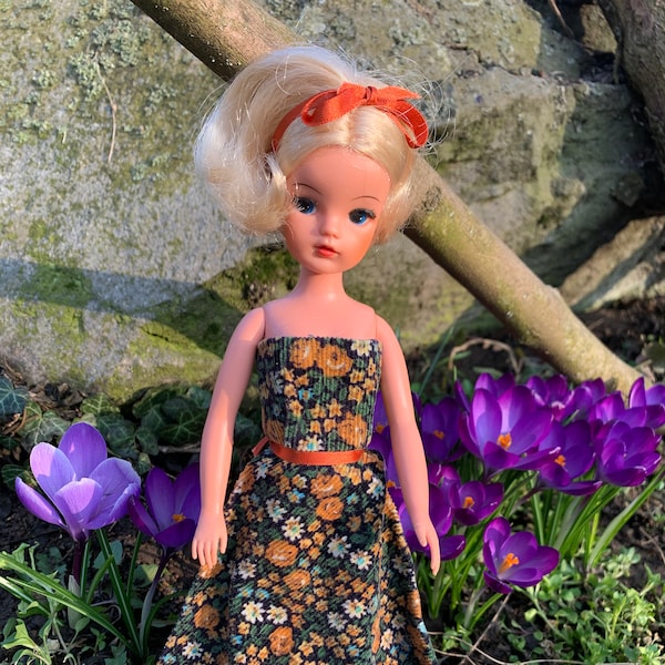 Wonderful vintage blonde Sindy doll toy, rooted eyelashes, bend legs, in vintage long flower pattern corduroy dress